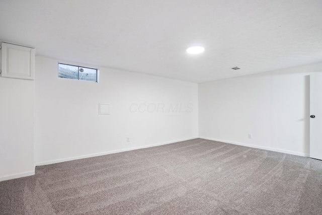 carpeted spare room with baseboards