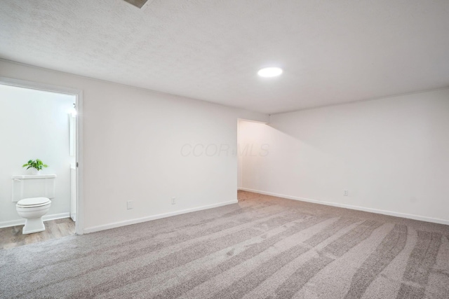 unfurnished room featuring baseboards, recessed lighting, a textured ceiling, and carpet flooring