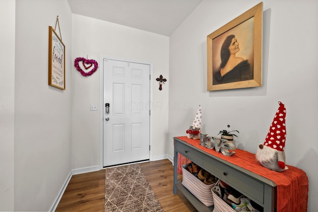 entrance foyer featuring dark wood-style flooring and baseboards