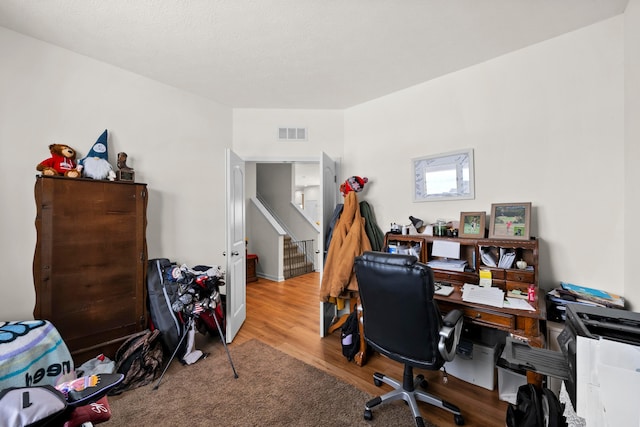 office space featuring wood finished floors and visible vents