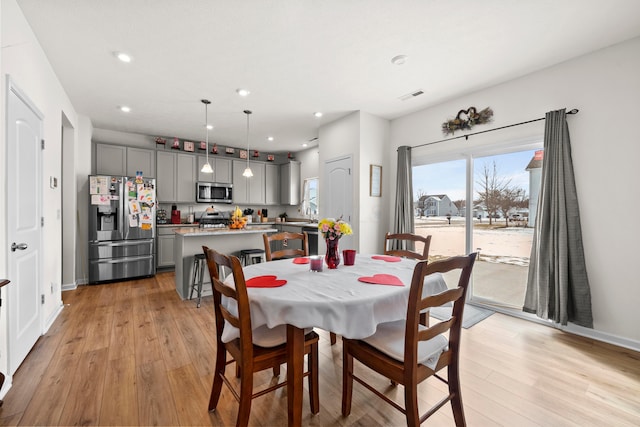 dining area with visible vents, recessed lighting, light wood-style flooring, and baseboards