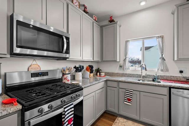 kitchen featuring a sink, gray cabinets, and appliances with stainless steel finishes