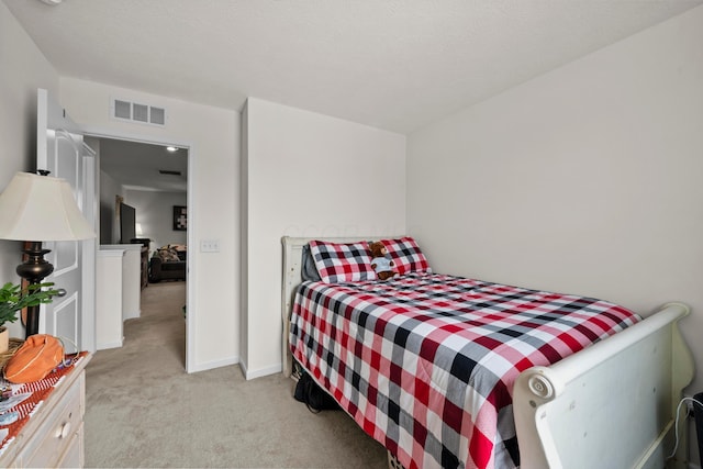 bedroom with light colored carpet and visible vents