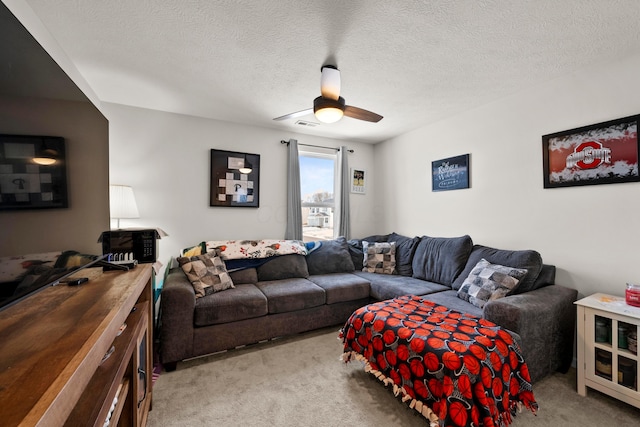 living room with light colored carpet, a textured ceiling, and a ceiling fan