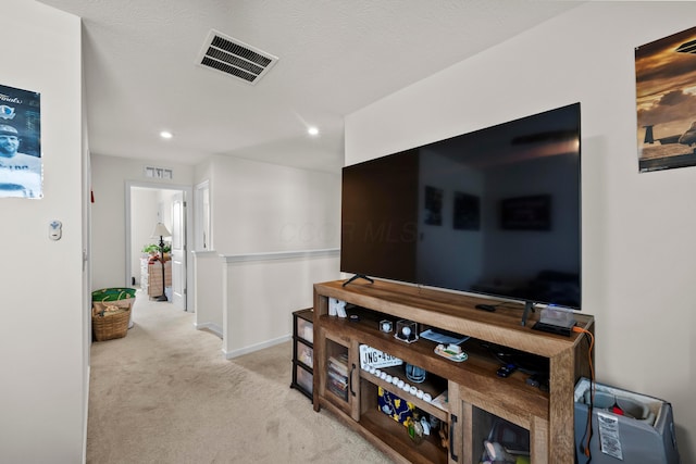 hallway featuring light carpet, baseboards, visible vents, and recessed lighting