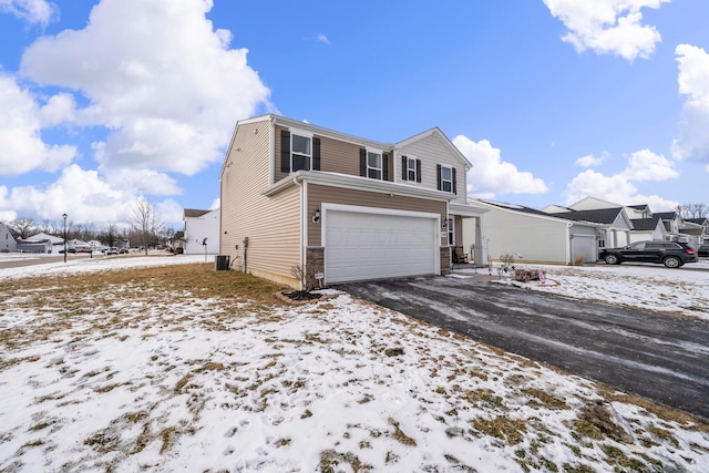 view of front facade with driveway, a residential view, and an attached garage