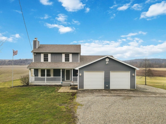 view of front of property featuring a porch, a garage, and a front lawn