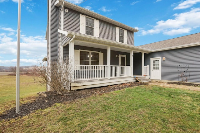 view of front of property featuring a porch and a front lawn