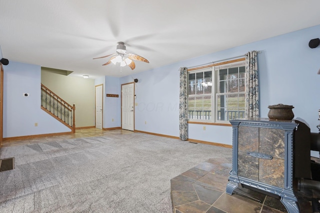 unfurnished living room featuring carpet floors and ceiling fan