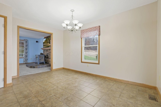 unfurnished dining area featuring a wood stove and an inviting chandelier