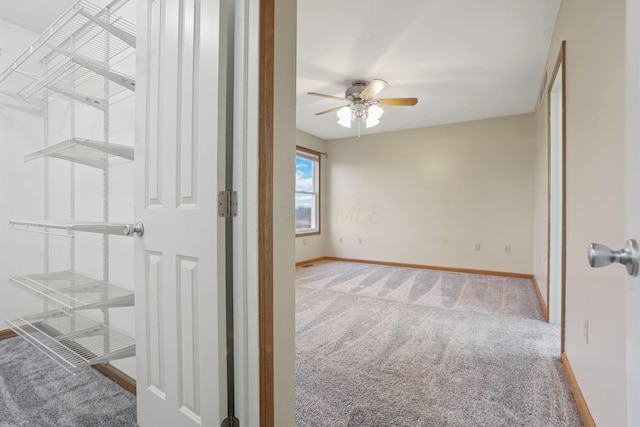 unfurnished room with carpet and ceiling fan