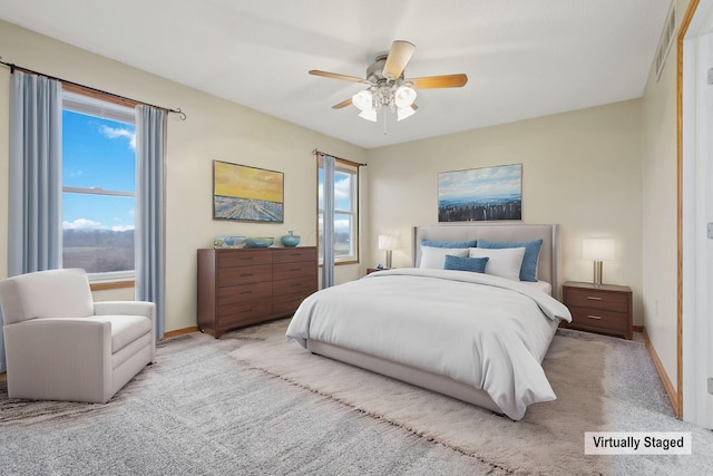 bedroom featuring light carpet and ceiling fan