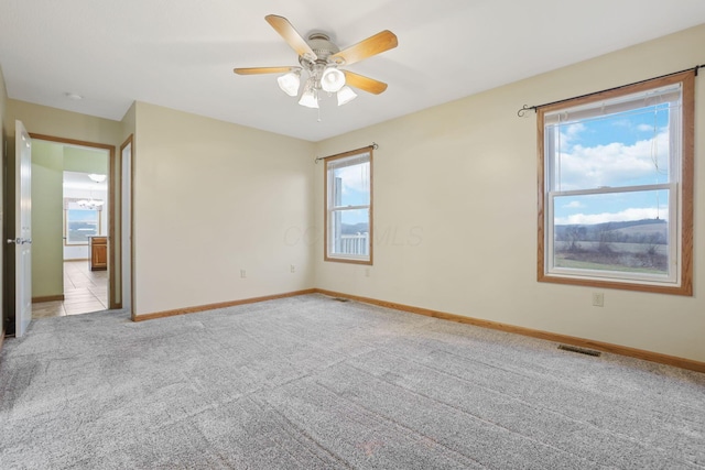 carpeted empty room with ceiling fan