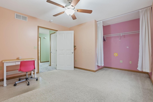 carpeted home office with ceiling fan