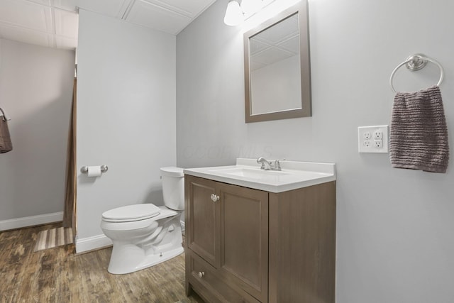 bathroom with vanity, hardwood / wood-style floors, and toilet