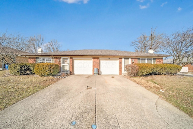 ranch-style home featuring a garage and a front lawn