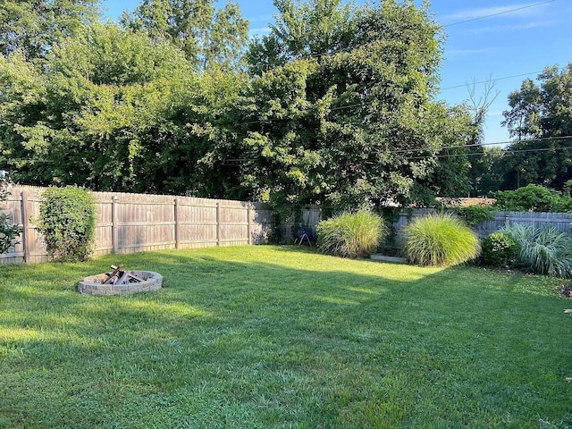 view of yard with a fire pit