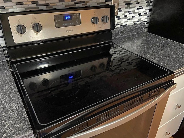 details featuring tasteful backsplash and stainless steel range with electric stovetop