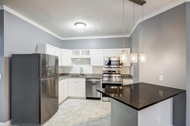 kitchen featuring a peninsula, a sink, appliances with stainless steel finishes, white cabinetry, and marble finish floor