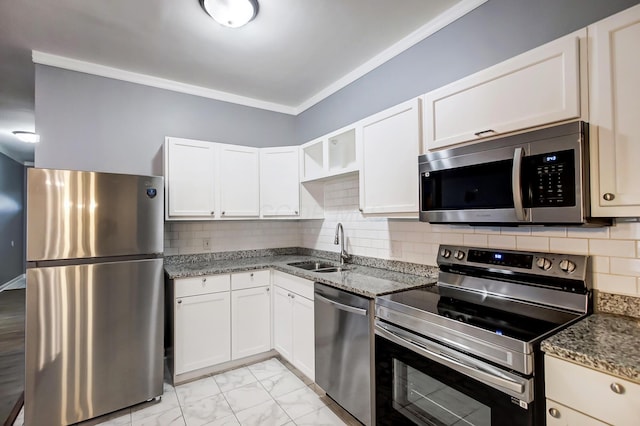 kitchen with stone counters, marble finish floor, appliances with stainless steel finishes, and a sink