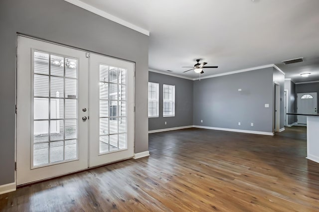 interior space with french doors, baseboards, wood finished floors, and crown molding