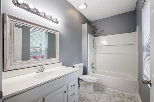 full bathroom featuring toilet, marble finish floor, a textured ceiling,  shower combination, and vanity