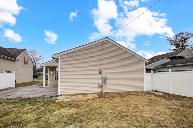 view of side of property with a lawn and fence