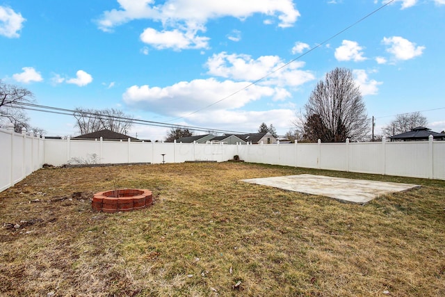 view of yard with a patio, a fire pit, and a fenced backyard