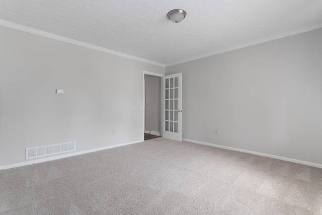 carpeted spare room with a textured ceiling, baseboards, visible vents, and crown molding