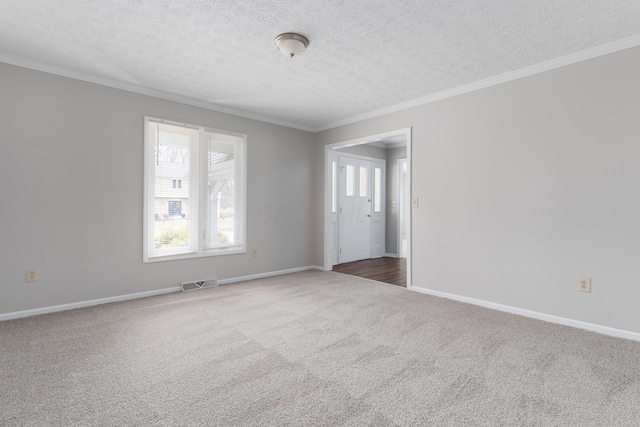 unfurnished room with crown molding, visible vents, dark carpet, and baseboards