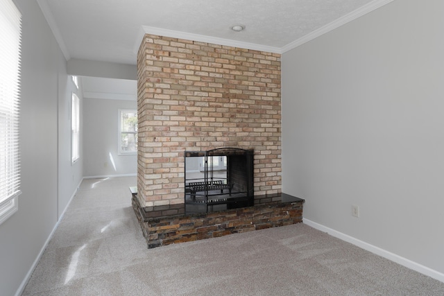 unfurnished living room featuring baseboards, ornamental molding, a textured ceiling, carpet floors, and a fireplace