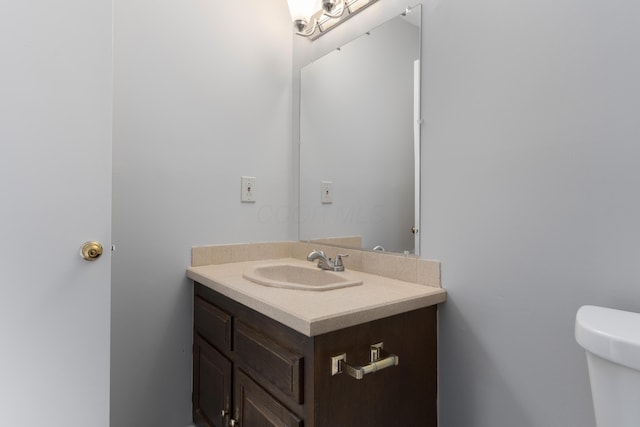 bathroom featuring toilet and vanity