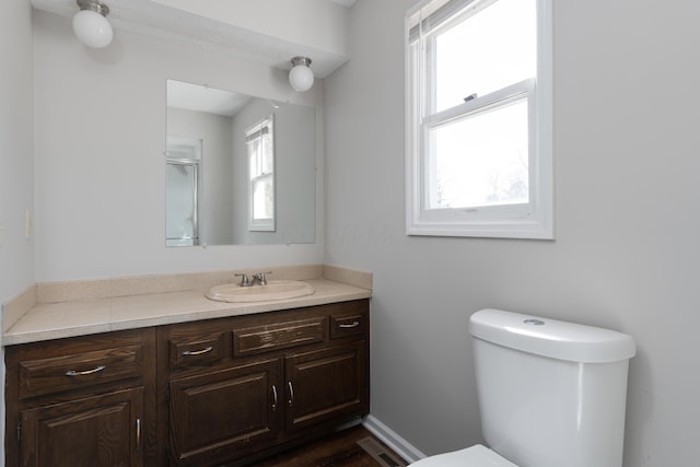 bathroom featuring visible vents, vanity, and toilet