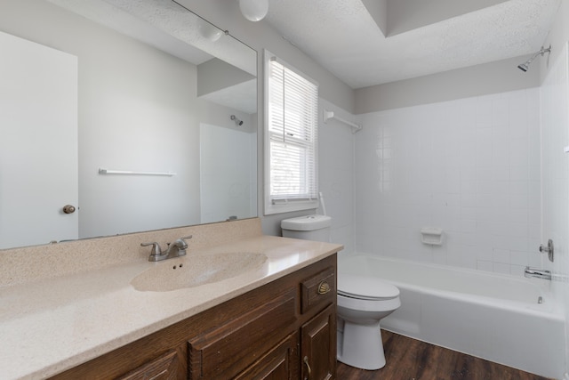 full bathroom featuring shower / bath combination, toilet, vanity, a textured ceiling, and wood finished floors