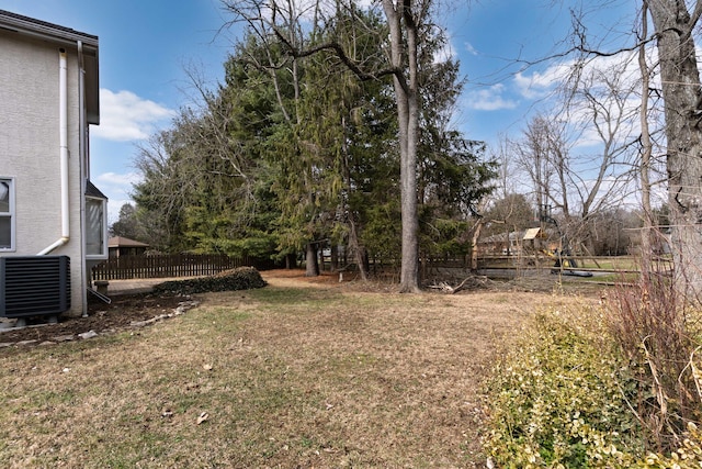 view of yard with fence and central AC