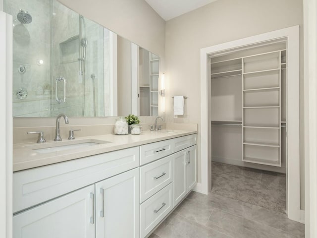 bathroom featuring tile patterned floors, vanity, and a shower with door