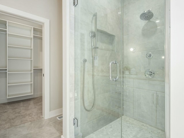 bathroom featuring a shower with door