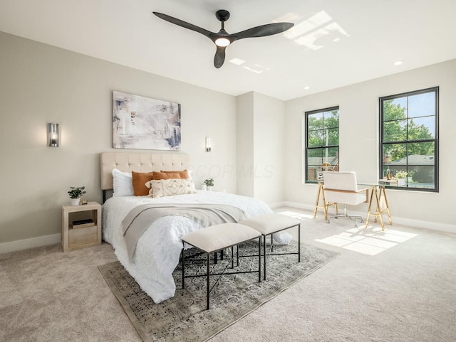 bedroom featuring ceiling fan and light carpet