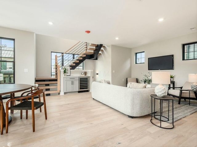 living room with light hardwood / wood-style flooring and beverage cooler