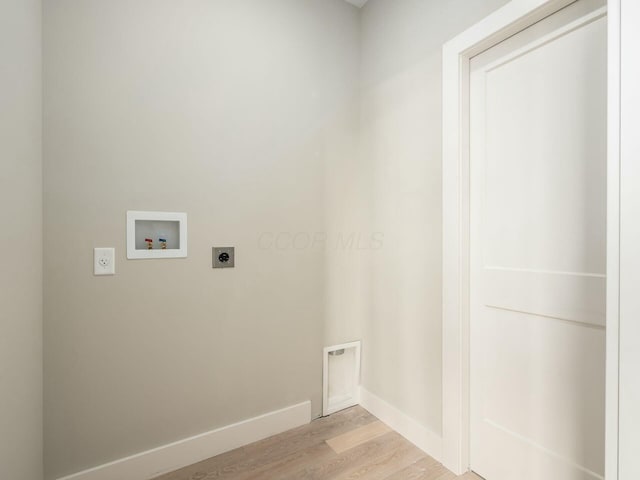 laundry area with electric dryer hookup, washer hookup, and light hardwood / wood-style floors