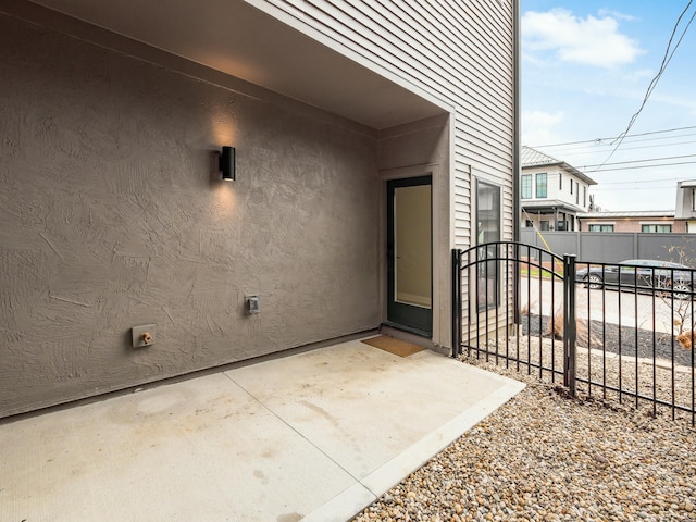 view of exterior entry featuring a patio area