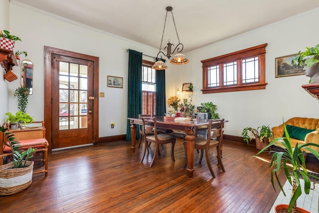 dining space with baseboards, dark wood-style flooring, and ornamental molding