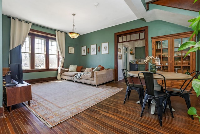 dining room with baseboards, dark wood-type flooring, and vaulted ceiling