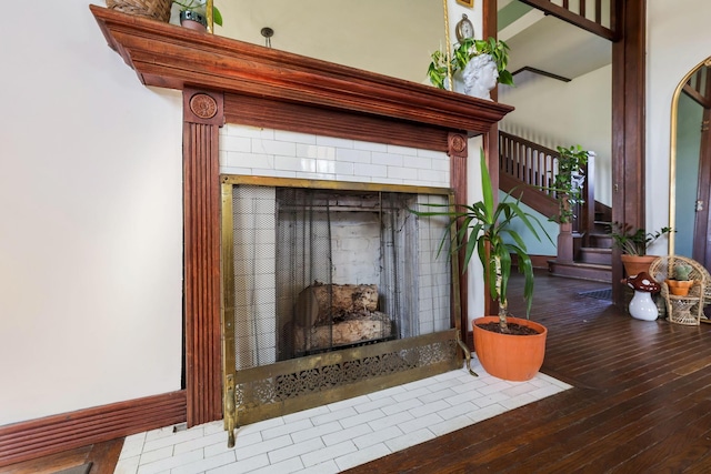 room details featuring wood finished floors and a tile fireplace