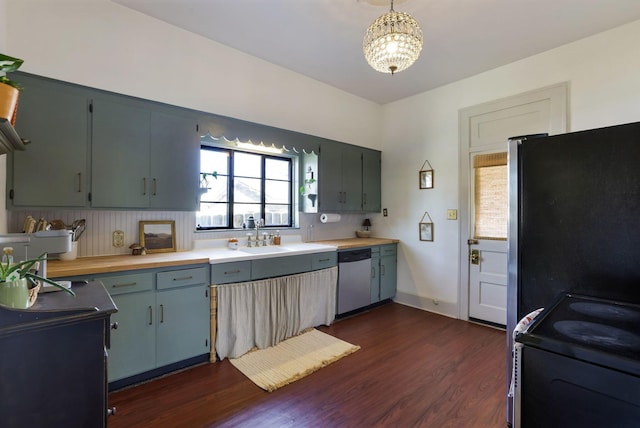 kitchen featuring dark wood finished floors, appliances with stainless steel finishes, light countertops, and a sink