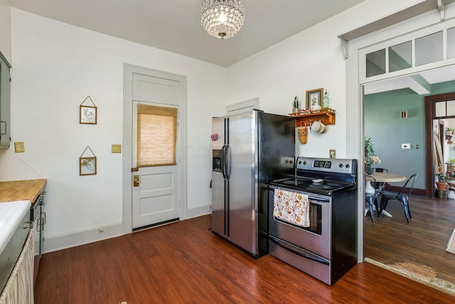 kitchen featuring stainless steel electric stove, baseboards, dark wood-type flooring, and fridge with ice dispenser