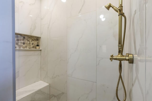 bathroom with a tile shower