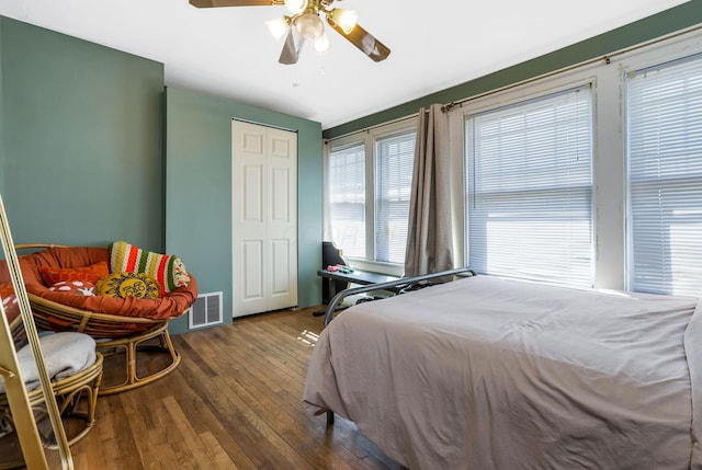 bedroom with visible vents, wood-type flooring, and ceiling fan