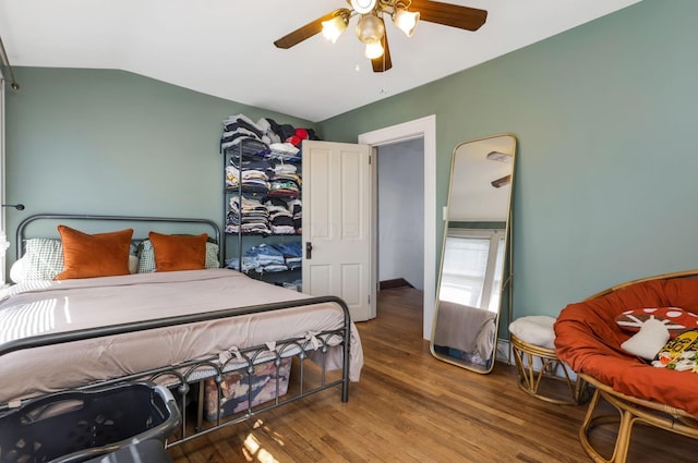 bedroom featuring vaulted ceiling, ceiling fan, and wood finished floors