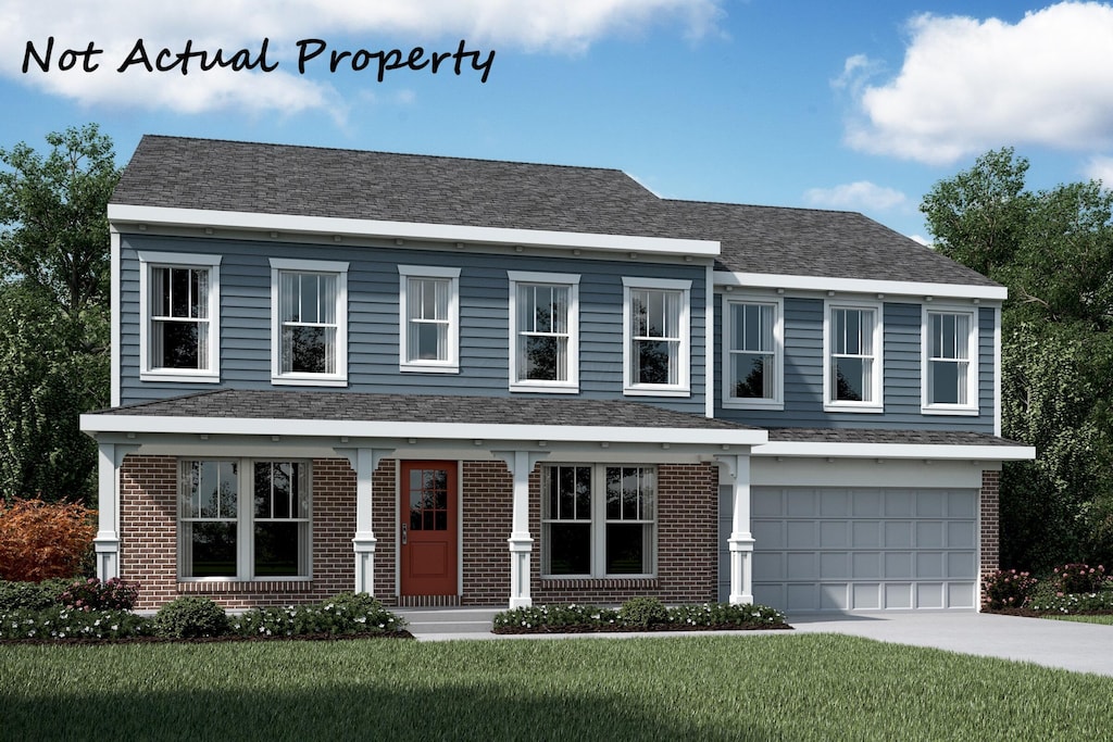 view of front of house featuring a garage and a front lawn